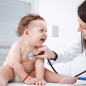 Doctor checking up baby with stethoscope.